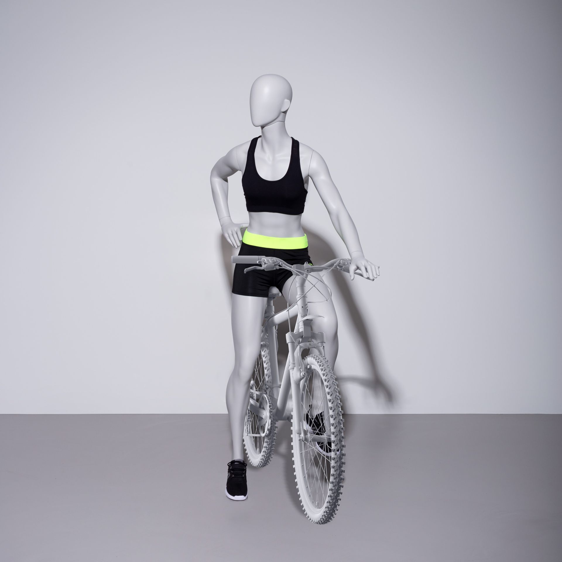 Cycling sport mannequin, female, grey, abstract head, standing posse 28